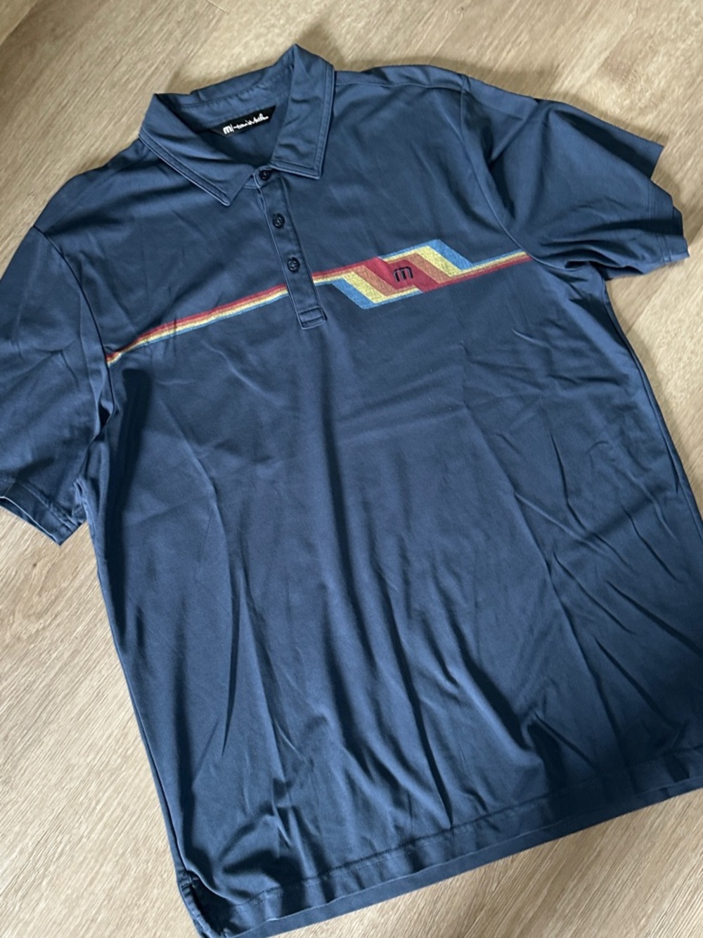 Travis Mathew Navy Polo with Multicolor Chevron Accent